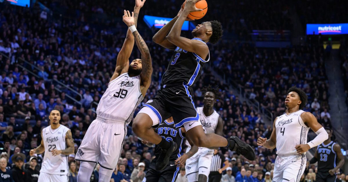 BYU forward AJ Dybantsa (3) looks to shoot over UCF forward Jordan Burks (99) during the first half an NCAA college basketball game, Tuesday, Feb. 24, 2026, in Provo, Utah. (AP Photo/Tyler Tate)