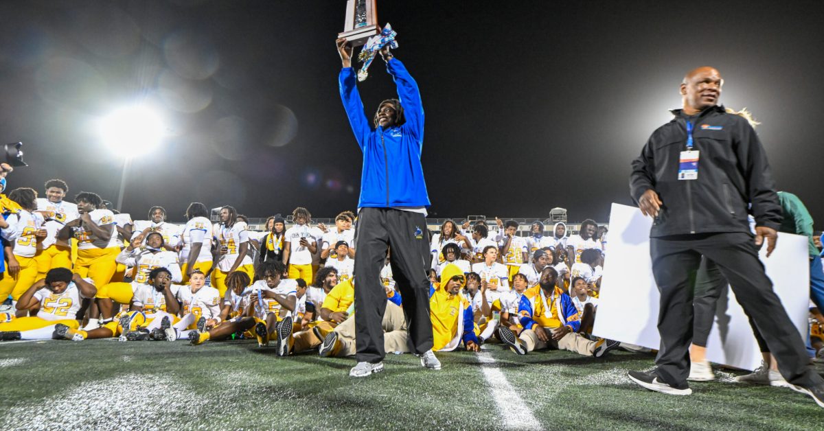 Miami Northwestern head coach, Teddy Bridgewater, hoisting the Florida High School Athletic Association (FHSAA) State Championship trophy after their win against Raines (Robson Lopes, Football Hotbed).